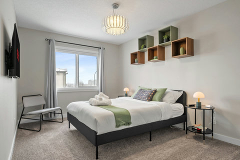 Stylish guest bedroom with curated wall shelves and natural light