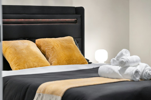 Stylish bedroom retreat with contemporary black bed and warm gold accents
