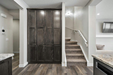 Elegant entryway with custom dark cabinetry and access to upper floors