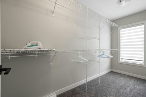 Well-equipped laundry room with ample storage and ironing facilities for extended stays