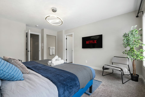 Stylish guest bedroom with entertainment and modern amenities throughout