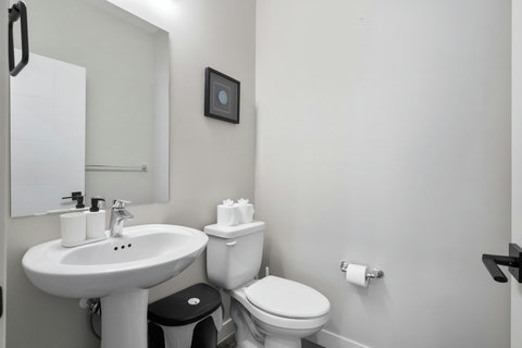 Spotless modern half bath with pedestal sink and contemporary fixtures