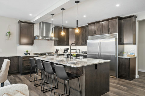 Chef's kitchen featuring granite island, pendant lighting, and premium appliances