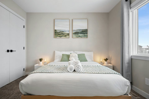 Peaceful guest bedroom with soft green touches and abundant natural light