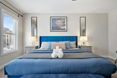 Stylish bedroom retreat with contemporary blue headboard and urban vistas