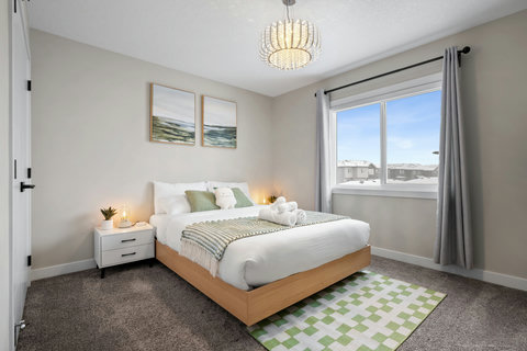 Comfortable guest bedroom with warm lighting and scenic views