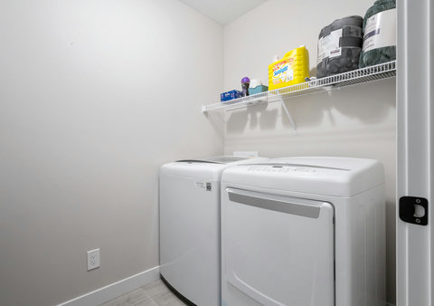 Convenient laundry room with modern washer and dryer for your stay