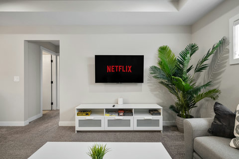 Comfortable living room with flat-screen TV and plenty of entertainment storage