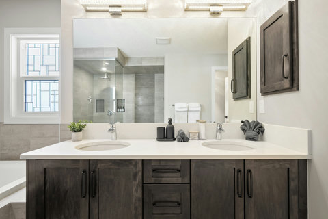 Spa-like master bath with double vanity and luxurious walk-in shower.