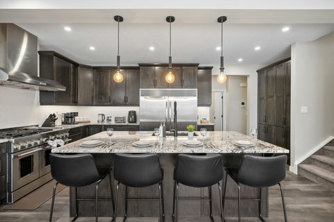 Chef's kitchen featuring stainless steel appliances and marble island seating