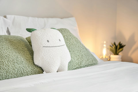 Comfortable bed styled with soft textures and charming decorative accents