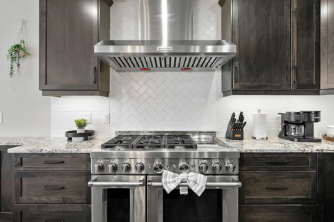 Chef's kitchen featuring professional dual ranges and stainless steel appliances