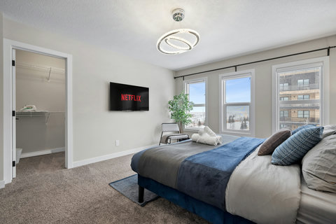 Bright master bedroom with stunning city views and Netflix entertainment