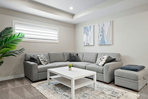 Spacious living room with plush sectional and natural light