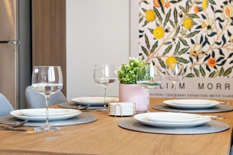 Beautiful 4 seater dining table with wine glasses, plates small and large, and bowls!