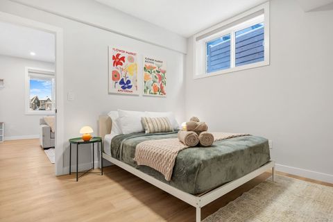 Queen bedroom with medium firm memory foam mattress & a cozy night lamp.