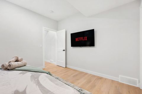 Master bedroom with a 50" Smart TV, plush towels, linens and a cozy mattress.
