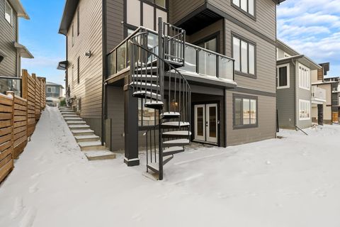 Beautiful snowy backyard with spiral staircase and modern patio space