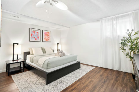 Bright and airy master bedroom with premium bedding and natural light