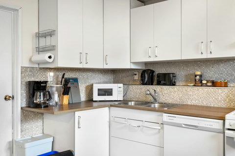 Bright, fully equipped kitchen with modern appliances and ample counter space