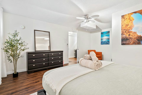 Bright and airy master bedroom with comfortable seating nook