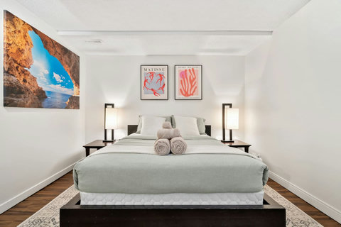 Stylish guest bedroom with modern furnishings and curated art collection