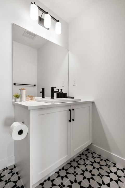 Master Bedroom Bathroom with Contemporary Design Stocked with Cotton Swabs, Cotton Pads, and Makeup Face Towels