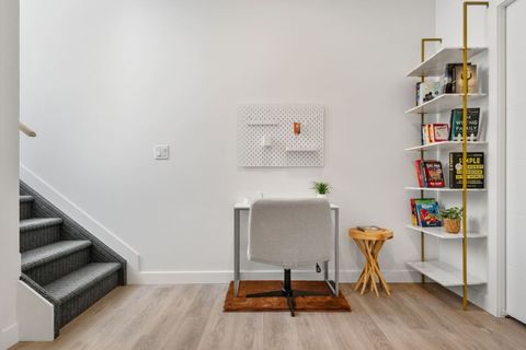 Stylish Office Space Designed for Productivity, Complete with a Practical Peg Board for Organization and a Decorative Bookshelf that Adds a Touch of Elegance