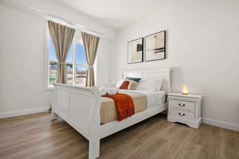 Enjoy a Vibrant Stay in this Stylish Queen Bedroom, With a Lively Mix of Red, Beige, and White Tones