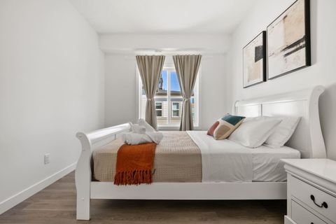 Cozy Queen Bedroom with Subtle Red Decorative Details, Adding a Touch of Warmth and Elegance to the Space
