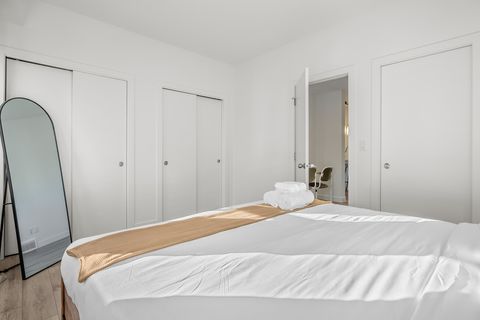 Serene guest bedroom with ample storage and natural light