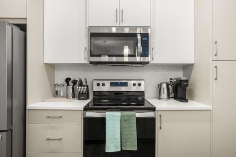 Fully equipped modern kitchen with stainless steel appliances and ample counter space