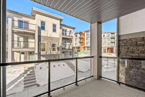 Stylish covered balcony with expansive views of the vibrant community courtyard
