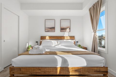 Serene main bedroom bathed in natural light with modern comfort