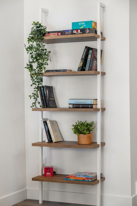 Stylish open shelving displays books, games, and fresh greenery beautifully