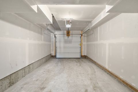 Spacious garage with automatic door opener and ample storage potential