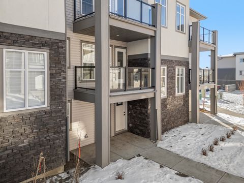 Stylish outdoor patio space with integrated fireplace and upper balcony access