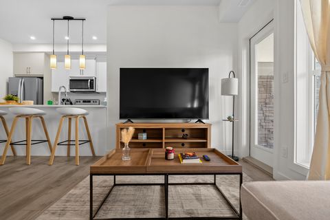 Stylish living space with flat-screen TV and warm wood furnishings