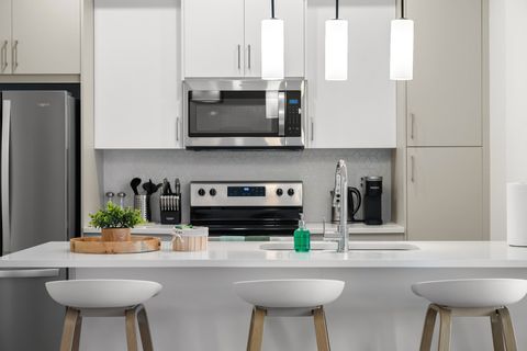 Sleek modern kitchen featuring stainless steel appliances and comfortable island seating