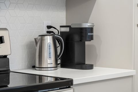 Well-equipped kitchen with electric kettle and single-serve coffee brewer