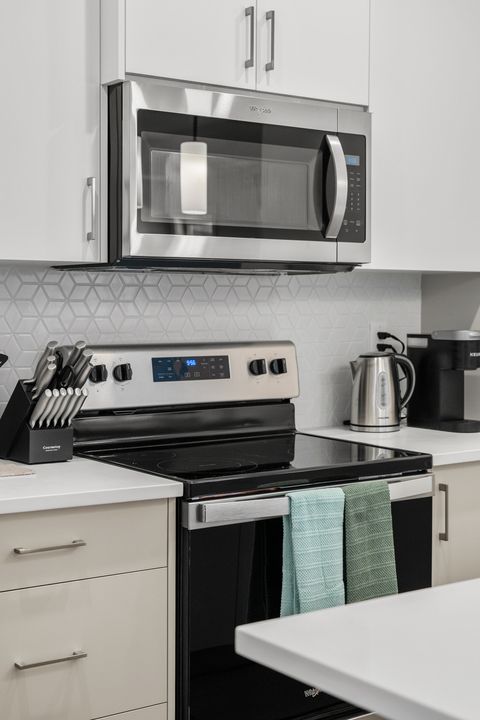 Fully equipped modern kitchen with stainless steel appliances and sleek design