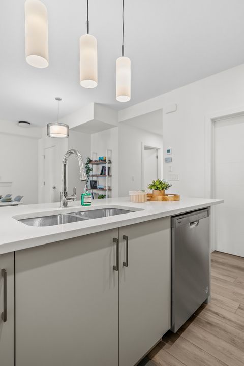 Bright modern kitchen featuring elegant pendant lights and chef-ready appliances