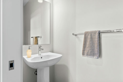 A clean and stylish half bath ready to welcome every guest