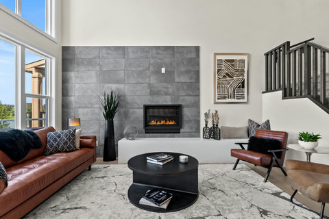 Gather around the glowing fireplace in this sleek, stylish living space