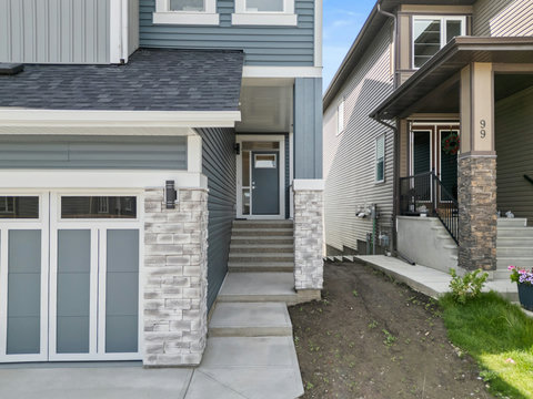 Welcoming front entrance with elegant stone accents and private covered doorway