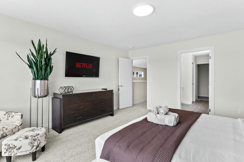 Unwind in this bright master suite with Netflix and a walk-in closet
