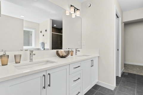Spa-like double vanity with gleaming quartz and stylish chrome details