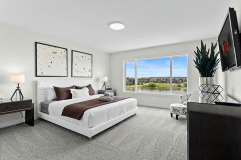 Wake up to serene lake views in this bright, elegant king bedroom