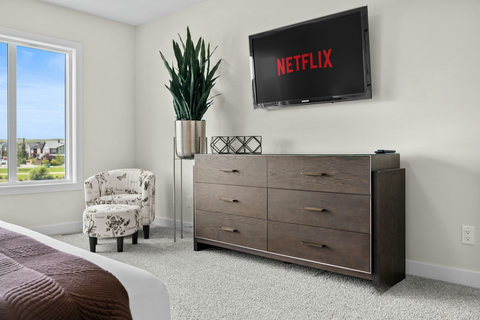 Cozy bedroom retreat with Netflix ready and natural light streaming in