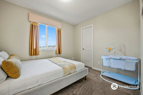Comfortable guest bedroom with natural light and city skyline views